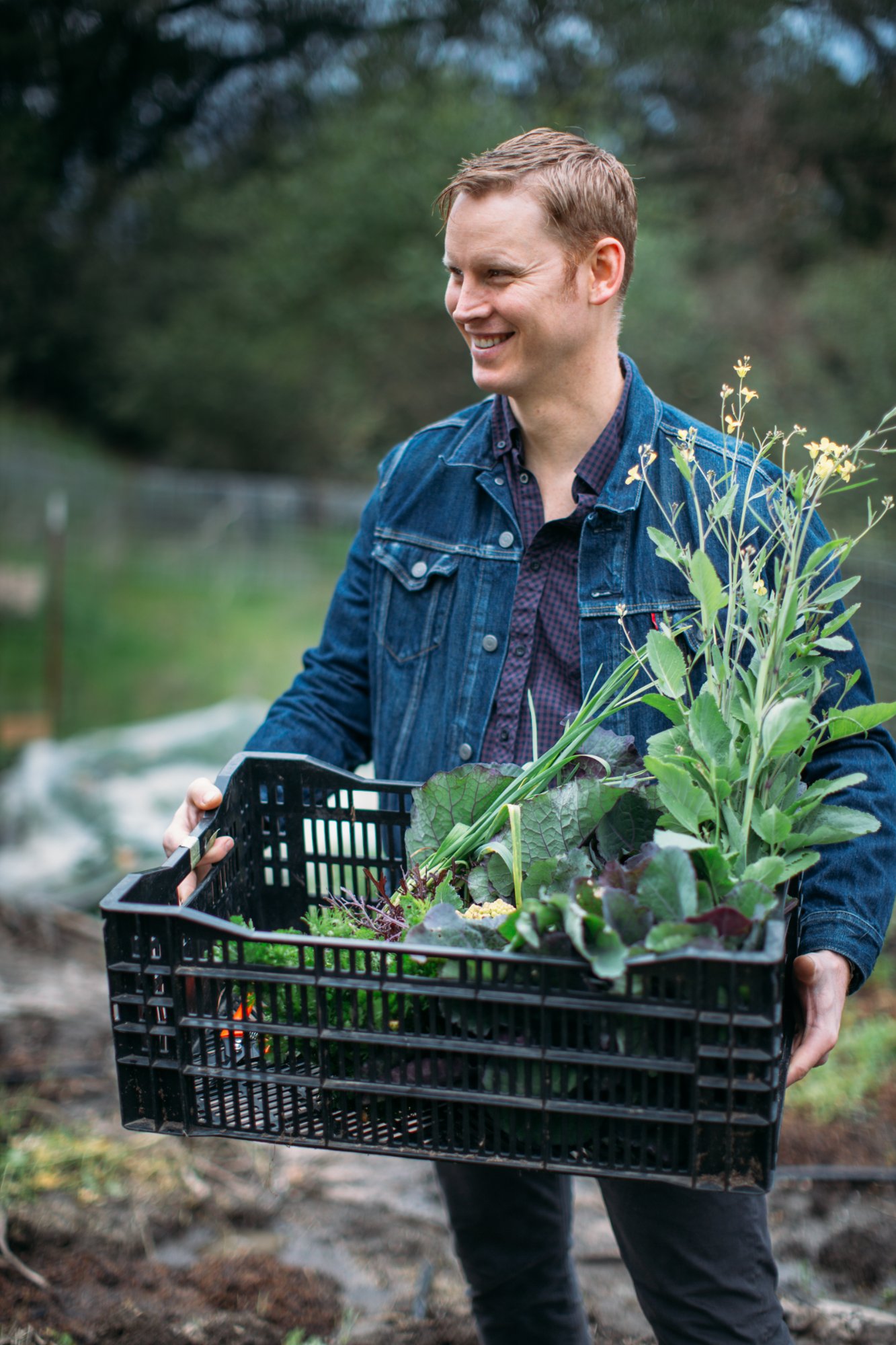 Erik Johnson, Founder of Longsummer Fine Foods, carrying fresh produce from a local farm